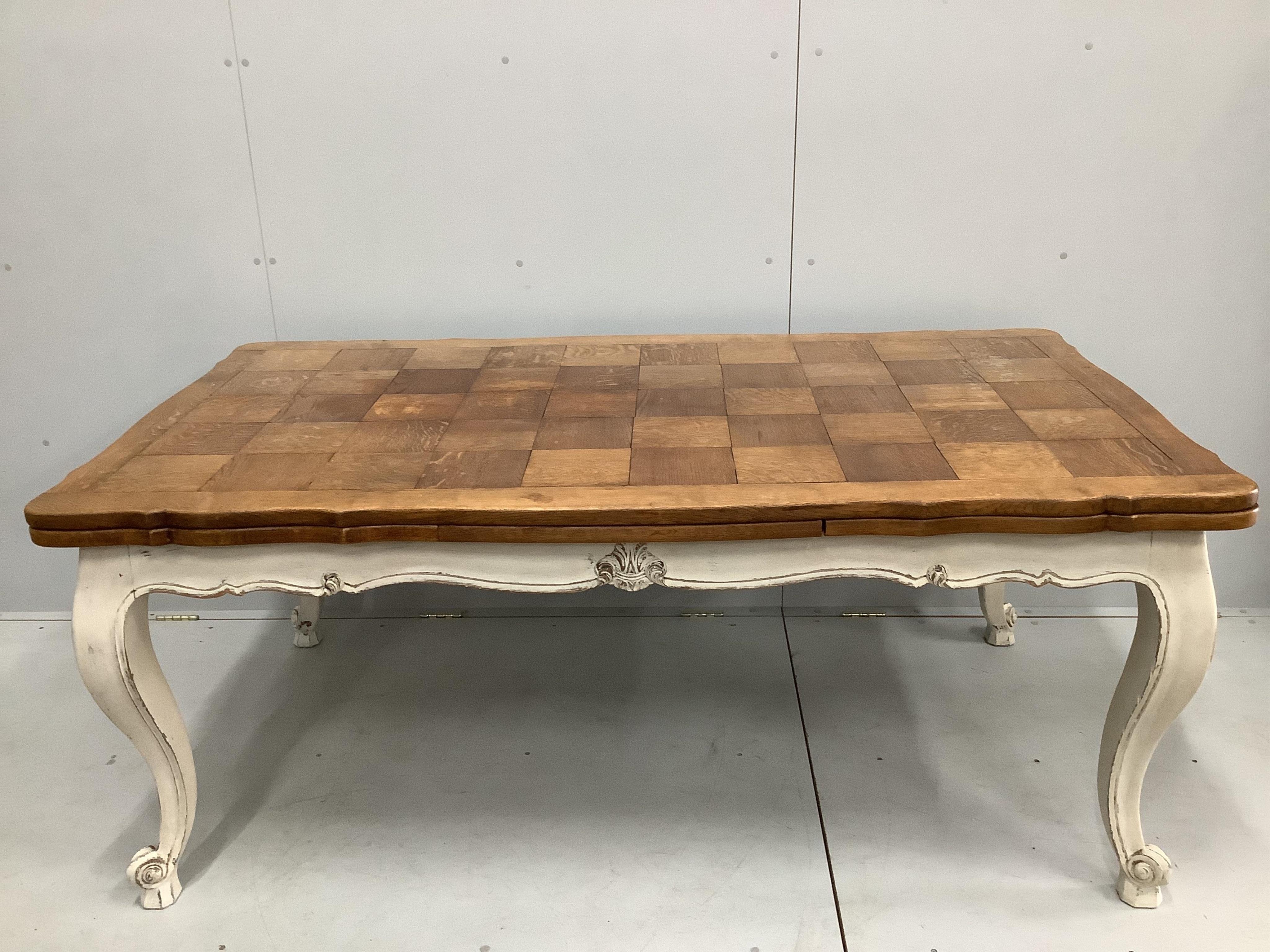 An early 20th century French part painted oak draw leaf extending dining table, width 300cm extended, depth 98cm, height 74cm